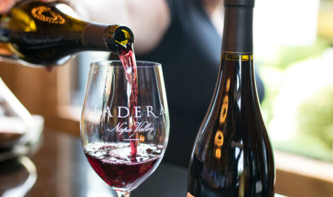 Pouring Ladera Pinot Noir into a glass
